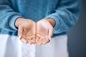 Image showing Hands open, charity and community with a woman begging for help in studio on a gray background. Support, poverty and palms with a female standing indoor to ask for aid, compassion or kindness