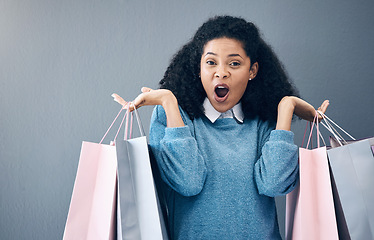 Image showing Wow, discount and portrait of woman with shopping bags, retail therapy and surprise at sale on wall. Deal, excited and happy girl holding products from a shop, market or mall on a background