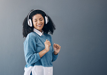 Image showing Dance, music and black woman in studio with freedom, streaming or good mood on grey background. Radio, podcast and girl relax while dancing to audio, online and playlist on advertising isolated space