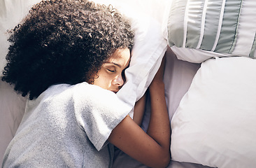 Image showing Sleeping, bedroom and relax with a black woman in bed, dreaming or resting in the morning at home. Sleep, tired and rest with an attractive young female asleep in her house over the weekend