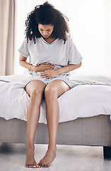 Image showing Black woman, stress or stomach ache on house bed, home or bedroom in period pain, menstruation cramps or ibs crisis. Hurt person, injury or abdomen tummy in healthcare emergency or appendicitis risk