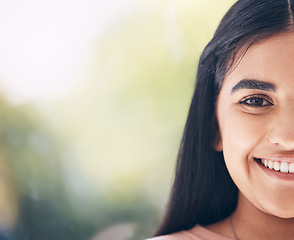 Image showing Portrait, face and mockup with an indian woman outdoor standing on a bokeh green background closeup. Half, happy and smile with an attractive young female posing on blank mock up space for branding