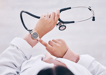 Image showing Top view, hands or doctor checking watch in hospital schedule, late appointment or medical biometrics. Woman, stethoscope or clock time in healthcare wellness visit, annual consulting or clinic visit