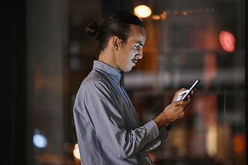 Image showing Phone, night and communication with a business man in his office, working late to make a global deadline. Mobile, contact and networking with a male employee at work using a smartphone app to email