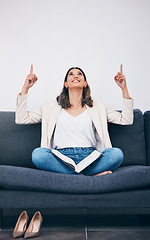 Image showing Reading, book and woman on sofa pointing for mockup, empty and blank copy space in living room. Advertising, marketing and girl on couch with story, literature and textbook for knowledge or research