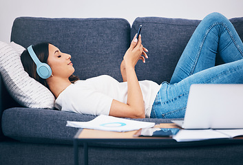 Image showing Headphones, sofa and woman student on study break for mental health, relax podcast and music streaming services. Smartphone, listening to audio and young person on couch with calm mindset or wellness
