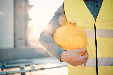 Image showing Engineering, helmet and hands of construction worker in lens flare for urban development and architecture mission. Building contractor, builder person or technician with safety gear on city rooftop