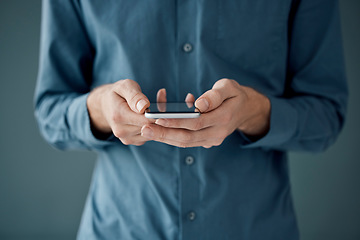 Image showing Hands, phone and networking for social media, communication or digital marketing against a studio background. Hand of person holding mobile smartphone for online chatting, conversation or app