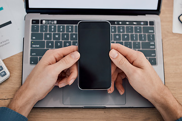 Image showing Hands, phone and green screen by laptop on mockup for advertising, marketing or networking at office desk. Hand of person with mobile smartphone on mock up display by computer in advertisement or app