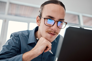 Image showing Serious man, internet and laptop in office for email, typing and creative, design and idea in business. Website, search and seo guy with glasses busy on online project, task and problem solving in IT