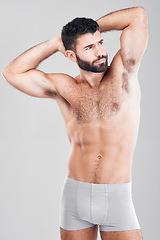 Image showing Fitness, body and a man underwear model in studio on a gray background for health or grooming. Aesthetic, muscle and manly with a handsome young male posing to promote wellness or lifestyle