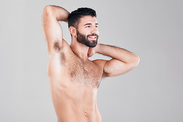 Image showing Fitness, muscles and sexy man in a studio after a bodybuilding workout or sport training. Health, wellness and muscular male model flexing his biceps while posing isolated by a gray background.