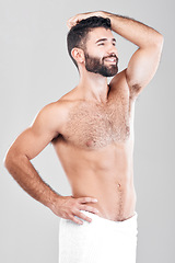 Image showing Health, skincare and shower, man with towel, grooming or bathroom routine with muscular body care in studio. Spa, wellness and cleaning skin treatment for fit male model isolated on grey background.