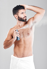 Image showing Man, armpit and spray deodorant in studio for hygiene, fresh scent or perfume. Male model spraying underarm for body odor, smell and cleaning cosmetics, shower product and skincare mist on background