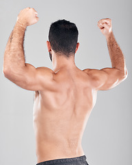 Image showing Flexing, muscle and fitness model or man with back strength after training isolated against a studio gray background. Wellness, workout and male person after exercise for body goal and biceps