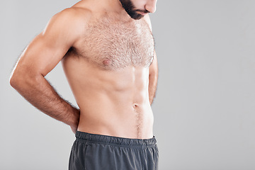 Image showing Insecurity, shirtless and man looking at body while isolated on grey studio background with mockup. Fitness, abs and topless model insecure about weight, stomach and waistline with space on backdrop