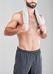 Image showing Fitness, man and model with a towel from morning shower after training or exercise. Health body, male and athlete in isolated gray background in a studio ready for skincare, hygiene and body care