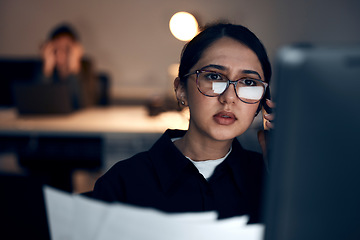 Image showing Computer, night research or programmer woman for cybersecurity, app coding or data analysis in office. Thinking, developer or employee on tech for software code, documents or startup analytics review