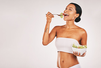 Image showing Health, eating or woman with a salad in studio for a healthy meal, nutrition diet or digestion benefits. Body goals, lose weight or happy hungry female model with food isolated on a white background