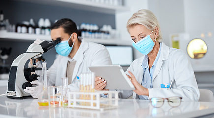 Image showing Scientist team, microscope and tablet for covid 19 vaccine research for pharma company, medical mask and dna. Man, woman and science reading, data analytics and futuristic goal with teamwork in lab