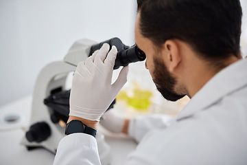 Image showing Microscope, medical and research with a man at work in a laboratory for science, innovation or development. Doctor, analytics and biotechnology with a male scientist working in a lab for breakthrough