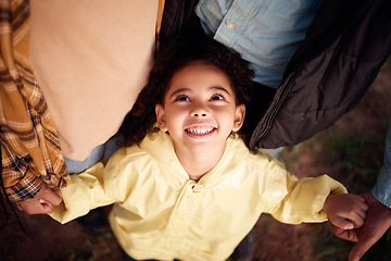 Image showing Above, holding hands and face of a girl with parents for love, support and care in nature. Happy, fun and playful child with mother, father and affection in the countryside of Australia for bonding