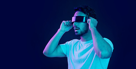 Image showing Man with vr headset, gamer and digital transformation for metaverse experience in technology. Person streaming augmented reality simulation, futuristic gaming and studio with dark background