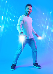 Image showing Hologram, metaverse and portrait of a man in a studio with a cyber, digital or scifi overlay for gaming. Virtual reality, futuristic and male gamer with a 3d fantasy experience by a blue background.