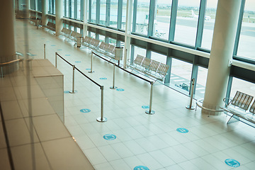 Image showing Travel, empty and floor of an airport building with space, architecture and waiting room for a plane. Design, clean and terminal for a check in while traveling, tourism and corridor entrance