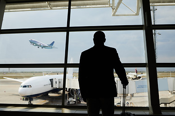 Image showing Airplane, travel or silhouette man watch plane fly, flight booking or transportation for world trip. Suitcase luggage, airport departure or back of person on holiday trip, vacation or global journey