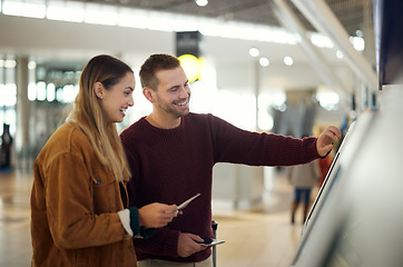 Image showing Couple in airport typing on self service screen for digital passport identity or flight data to travel on airplane. Smart check, woman or happy man pressing code for on futuristic technology at kiosk