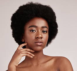 Image showing Portrait, skin or natural and a model black woman in studio on a gray background with afro hair. Skincare, cosmetics and beauty with an attractive young female posing indoor for health or wellness