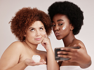 Image showing Skincare, funny and facial with friends and selfie for product, beauty and spa. Comic, phone and social media with black women and silly face photo with cream for health, makeup or wellness in studio