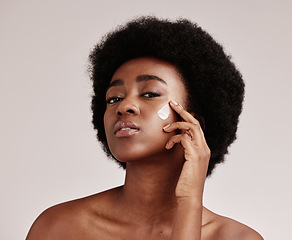 Image showing Beauty, portrait of black woman with cream on face and afro, advertising luxury skincare with collagen product promotion. Dermatology, cosmetics and spa facial for model isolated on studio background