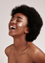 Image showing Beauty, smile and black woman with cream on face, afro and excited advertising for luxury skin product promotion. Dermatology, cosmetics and salon facial for happy model isolated on studio background