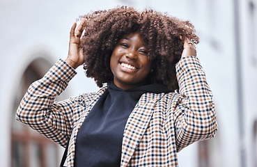 Image showing Black woman, portrait and afro hair in city fun, goofy or silly travel in urban New York or holiday location. Smile, happy or playful student in fashion, trendy or cool clothes with natural hairstyle