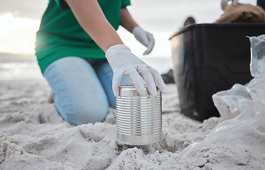 Image showing Recycle, volunteer hand cleaning beach and can in sand, picking up dirt at ocean on earth day. Community service, sustainability and environmental charity, people pick up trash for future of planet.