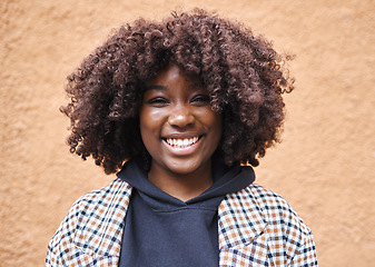 Image showing Black woman, portrait and afro on wall background in city, urban town or fun in Kenya. Happy young african female smile for happiness, face and curly hair outdoors with fashion, motivation or freedom