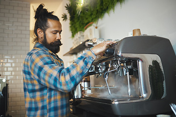 Image showing Man in cafe, barista working machine and create drink with focus and small business, workflow and process. Espresso, latte or cappuccino production, busy server in coffee shop with steam for cleaning