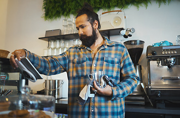 Image showing Coffee, tablet and barista reading orders, checklist or inventory online while working at a cafe. Service, morning and man with technology ordering supplies, product and connection with supplier