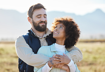 Image showing Love, happy and hug with interracial couple on farm for agriculture, peace and growth. Teamwork, countryside and nature with man and black woman in grass field for sustainability, agro or environment