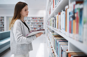 Image showing Bookshelf, student or woman in library search for research, education or learning on tablet. Scholarship, study or girl on tech for university mobile app or planning school project at collage campus