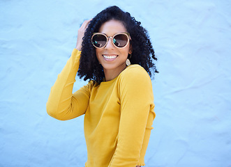 Image showing Fashion sunglasses, portrait and black woman on blue background, excited face and trendy cool clothes. Summer, shades and happy girl model smile with vision, yellow color style and urban wall mockup