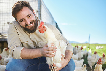 Image showing Chicken, farmer and man on livestock farm for sustainable, agriculture and environmental farming. Eco friendly, organic and agro male with poultry animal for his industry business in the countryside.