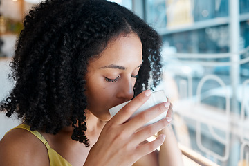 Image showing Black woman, relax or drinking coffee in cafe or restaurant for lunch break, mindfulness or self love zen. Beverage, student or person with tea cup drink for personal time, inspiration or calm peace