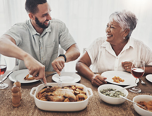 Image showing Love, mother and adult son cut chicken, event and conversation with happiness, family and loving together. Happy, mama and male child with food, smile or enjoy party for quality time or weekend break