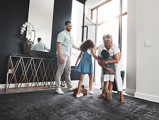 Image showing Family, grandmother and children hug as greeting in a home or house due to grandparent visit on holiday or vacation. Kids, grandchildren and elderly woman embrace feeling excited, happy and happiness