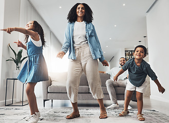 Image showing Happy family, fun and dance in a living room by mother and children playing, bonding and happy in their home. Kids, parents and dancing game in a lounge on a weekend, cheerful and happiness together