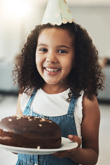 Image showing Portrait of happy girl with birthday cake, child in home and surprise celebration in Atlanta house alone. Young kid with smile in homemade chocolate dessert, hat on curly hair and excited african