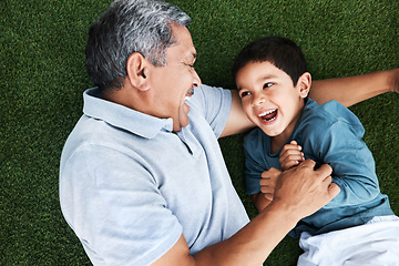 Image showing Grandfather, child and laughing on grass having fun with love and grandparent care. Laugh, happy kid from above and senior man together outdoor on summer vacation with family and bonding in nature